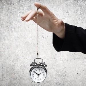 Close up of businessman holding clock on rope-782193-edited.jpeg