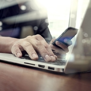 designer hand working and smart phone and laptop on wooden desk in office with london city background-359801-edited.jpeg